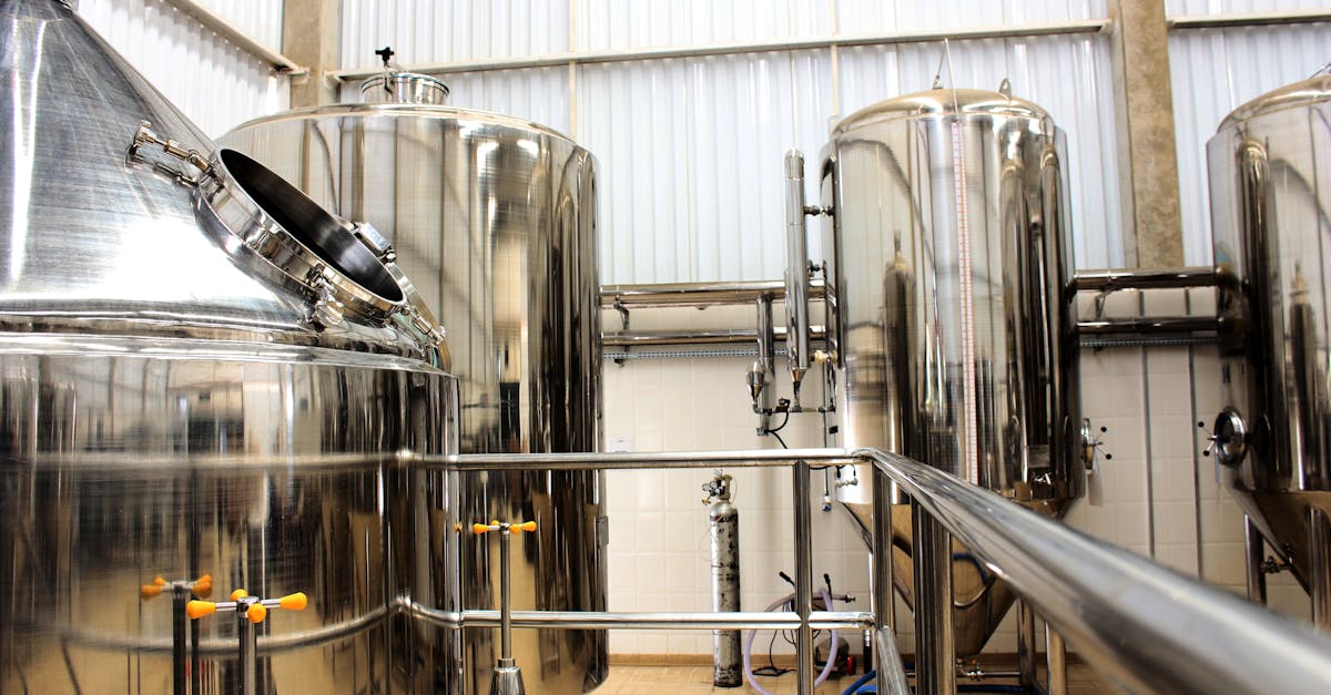 a view of stainless steel tanks in a modern brewery showcasing industrial machinery and production